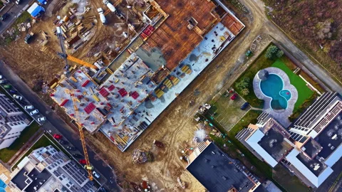 Construction project seen from above with buildings, a pool, and construction Stock Footage 335395399