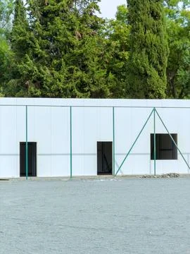 Construction project showing progress on a building structure made of white.. Stock Photos