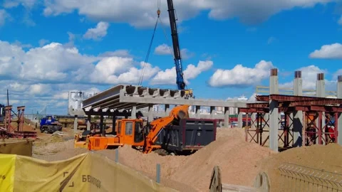 Construction project shows crane lifting concrete beams in urban area Stock Footage 338316991
