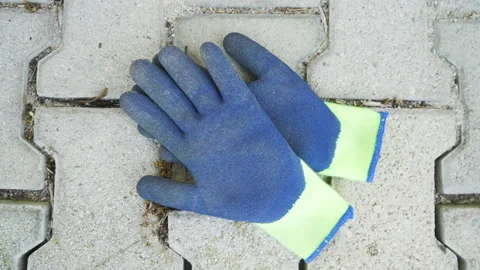 Construction protective working gloves on the ground, static shot. Stock Footage 133611168