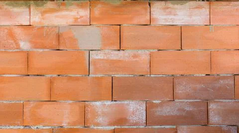 Construction red brick cinder block and fence facade wall background masonry Stock Photos