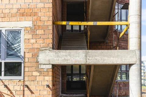 Construction of a red brick multi-storey building. 스톡 사진