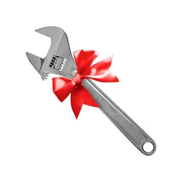 Construction, repair, tools - Gift adjustable spanner a red bow. Isolated Stock Photos