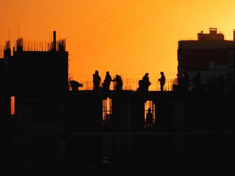 Construction of residential building. Builders go on the unfinished floor wit Stock Photos