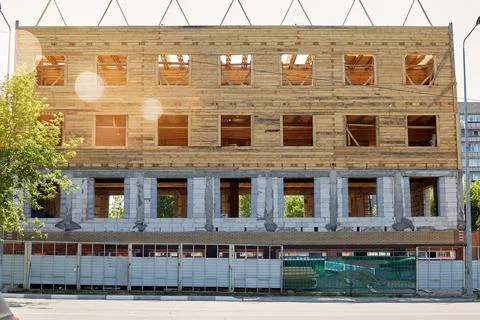 Construction of a residential building made of bricks and wooden logs Stock Photos