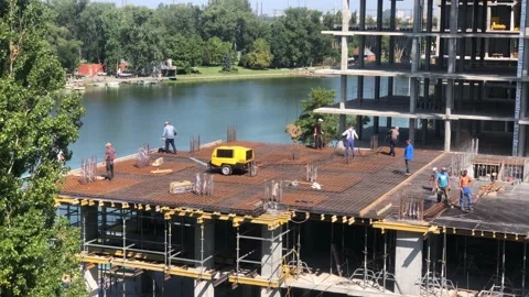 Construction of a residential building next to the river. The process of Stock Footage 199094244