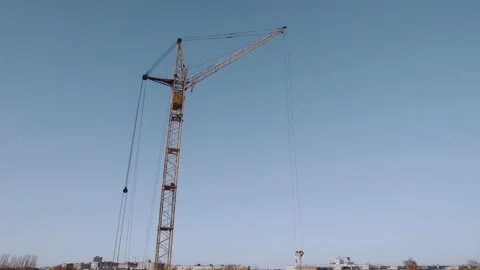 Construction of a residential building with a tower crane in winter Stock Footage 171876187