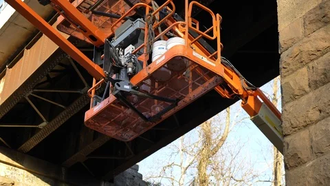 Construction rig underneath train overpass Stock Footage 127188235