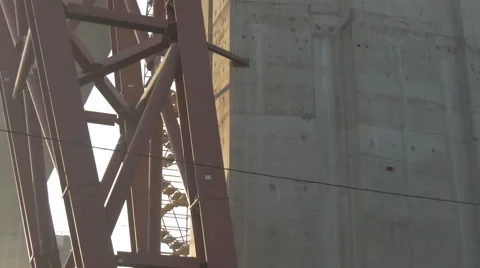 The construction of the road bridge. The view from below on a massive crane, uhd Stock Footage 64886075
