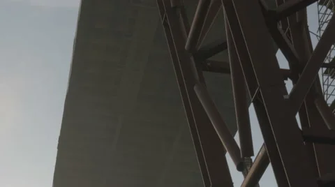 The construction of the road bridge. The view from below on a massive crane, uhd Stock Footage 64886344