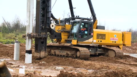 Construction of the road on the bridge. Worker on a machine with a hammer at a Stock Footage 95189329