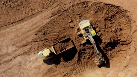 Construction of a Road Interchange.Excavator Bucket Loads Sand into the Dump Stock Footage 223322631