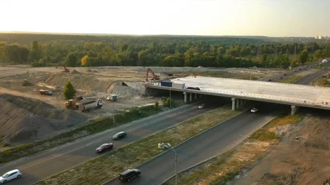 Construction of a road junction with a bridge over the road outside the city Stock Footage 161235470