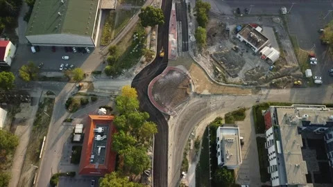 Construction on road project in urban area shows progress with machinery and new Stock Footage 335333642