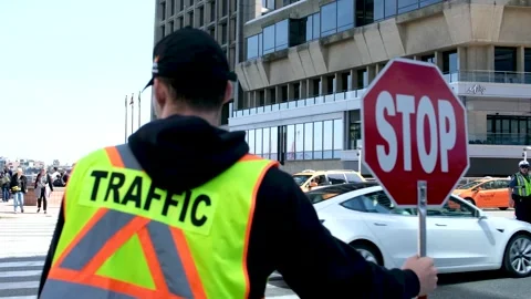 A construction road worker stopping traffic, holding a stop sign. Stock Footage 241387369