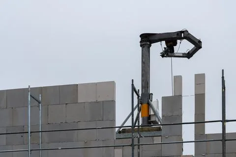Construction robot laying blocks at a building site Stock Photos