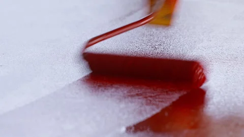 A construction roller applies paint to the surface. Stock Footage 270413902