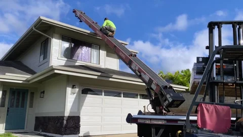 Construction Roofer Worker Riding Conveyor Belt Machine To Get Up On House Roof Stock Footage 240571865