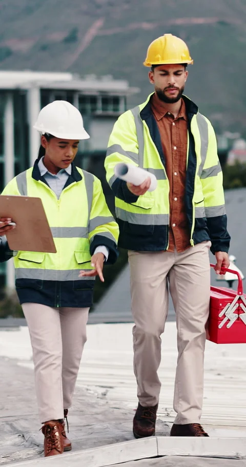 Construction, rooftop and people with clipboard, toolbox and blueprint for Stock Footage 336704337
