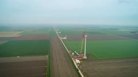 Construction of Row of Windmills with Crane in Flevoland, Netherlands / Holland  Stock Footage 119102059