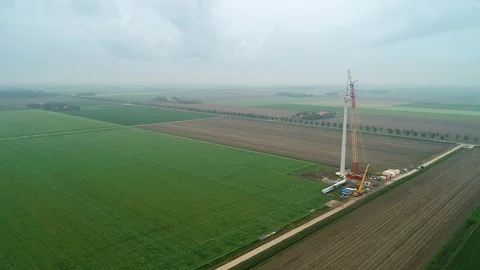Construction of Row of Windmills with Crane in Flevoland, Netherlands / Holland  Stock Footage 119102096