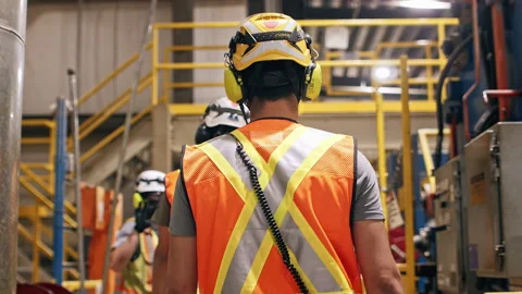 Construction safety workers walking in slow motion through factory Stock Footage 168462825