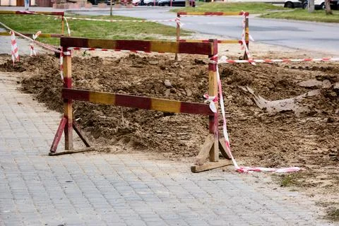Construction safety zone. Urban maintenance barriers and warning tape. Stock Photos