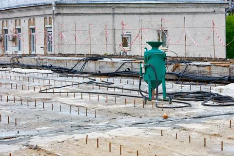 A construction sandblasting machine stands on a work platform for sandblastin Stock Photos