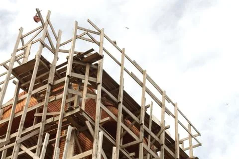 Construction with scaffold pole platforms. Building or reconstruction concept Stock Photos