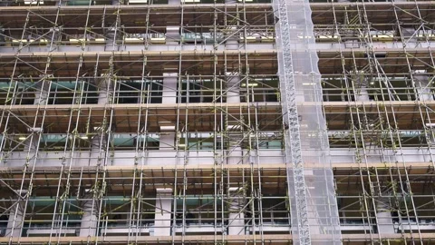 Construction scaffolding covers building exterior undergoing renovation and.. Stock Footage 339373359