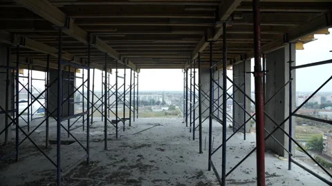 Construction scaffolding inside unfinished high-rise building floor Stock Footage 318588520