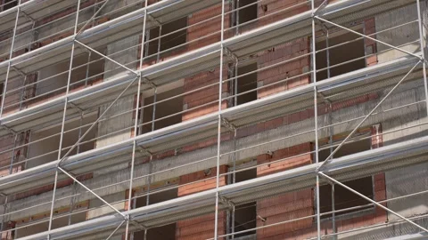 Construction scaffolding on red brick building facade Video stock 311638033