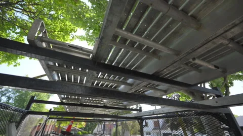 Construction scaffolding viewed from below, showing the metal platform with Stock Footage 318629490