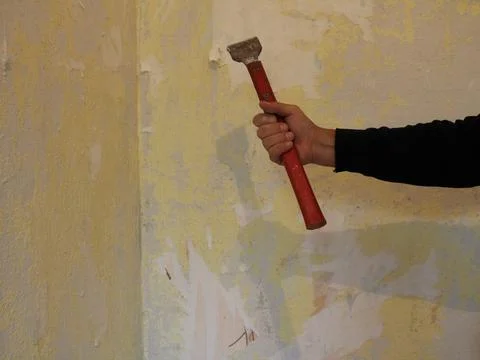 Construction scraper in builder's hand Stock Photos