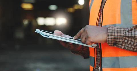 Construction, scroll or hands on site with tablet, task brief or inspection Stock Photos