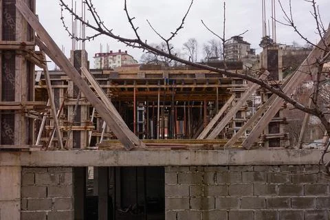 The construction of the second floor of a monolithic house has been stopped. Stock Photos