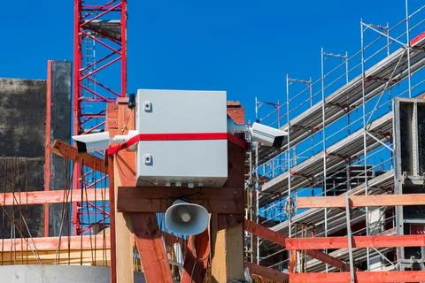 Construction security system installation at a building site Stock Photos