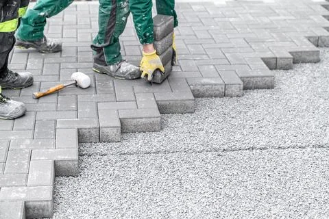 Construction of a sidewalk from concrete blocks Stock Photos