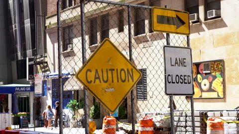 A construction sign board saying Caution and Lane Closed with a right arrow. Stockbeeldmateriaal 333152883