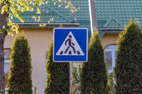 Construction Sign Stands in Front of a House With Green Roof and Trees on a.. Stock Photos