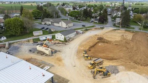Construction Site Activity in Small Town on a Sunny Day With Machinery and .. Foto stock