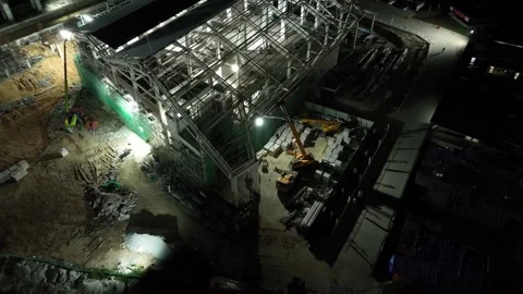 Construction Site Aerial View at Night with Heavy Machinery Operations Stock Footage 312142895