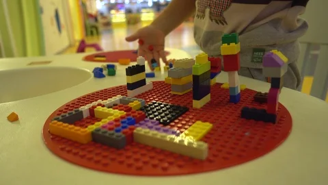 Construction site and the child building it with colourful interlocking brick Stock Footage 92219684
