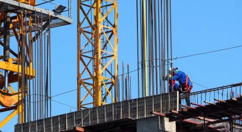 Construction site and labor working on high building. Stock Photos