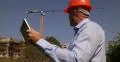 Construction Site Architect Engineer Verify Building Structure Plan Using Tablet 4k or 4k+ Resolution