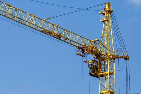 Construction site background. Hoisting cranes and new multi-storey buildings. Stock Photos
