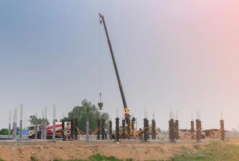 Construction site background. Hoisting cranes and concrete truck Foto stock