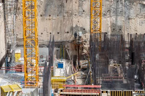 Construction site background. Hoisting cranes and new multi storey buildings Stock Photos