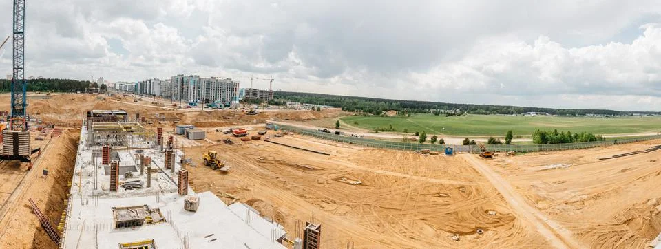 Construction site background. Hoisting cranes and new multi-storey buildings Stock Photos