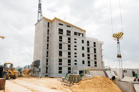 Construction site background. Hoisting cranes and new multi-storey buildings Stock Photos
